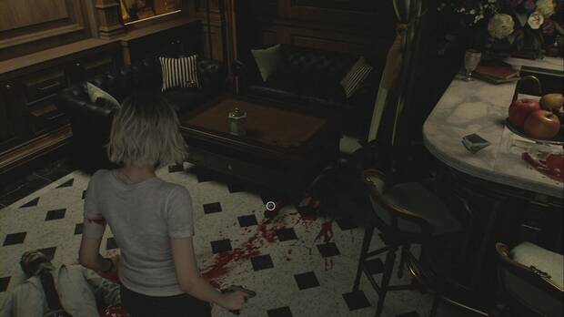 Resident Evil Requiem - Centro de pacientes (III), brazo bajo la mesa de la Sala de juegos, junto al cadáver