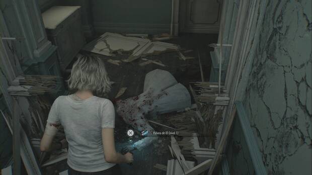 Resident Evil Requiem - Centro de pacientes (III), cadáver del pasillo este de la primera planta del ala este que lleva encima la Pulsera de ID (nivel 1)