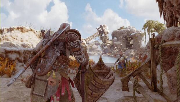 God of War: Ragnarok - En busca de Tyr: Kratos empuja una barca en dirección al agua. Al fondo, Atreus se aparta del camino para subirse a ella cuando ésta flote