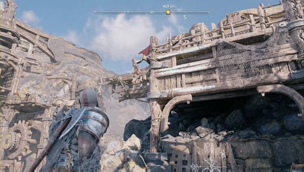 God of War: Ragnarok - En busca de Tyr: Kratos espera en tierra firme mientras Atreus escala por los salientes de la estructura de la mina