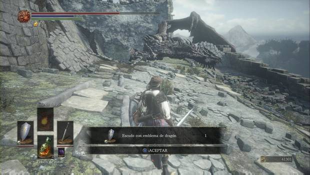 Dark Souls III - Torreón de Farron: escudo con emblema de dragón junto al cadáver del dragón en la muralla