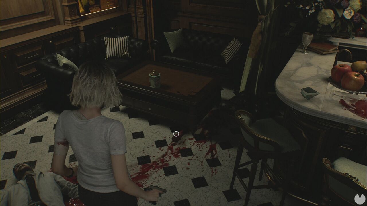 Resident Evil Requiem - Patient Center (III), arm beneath the table in the Game Room beside the corpse